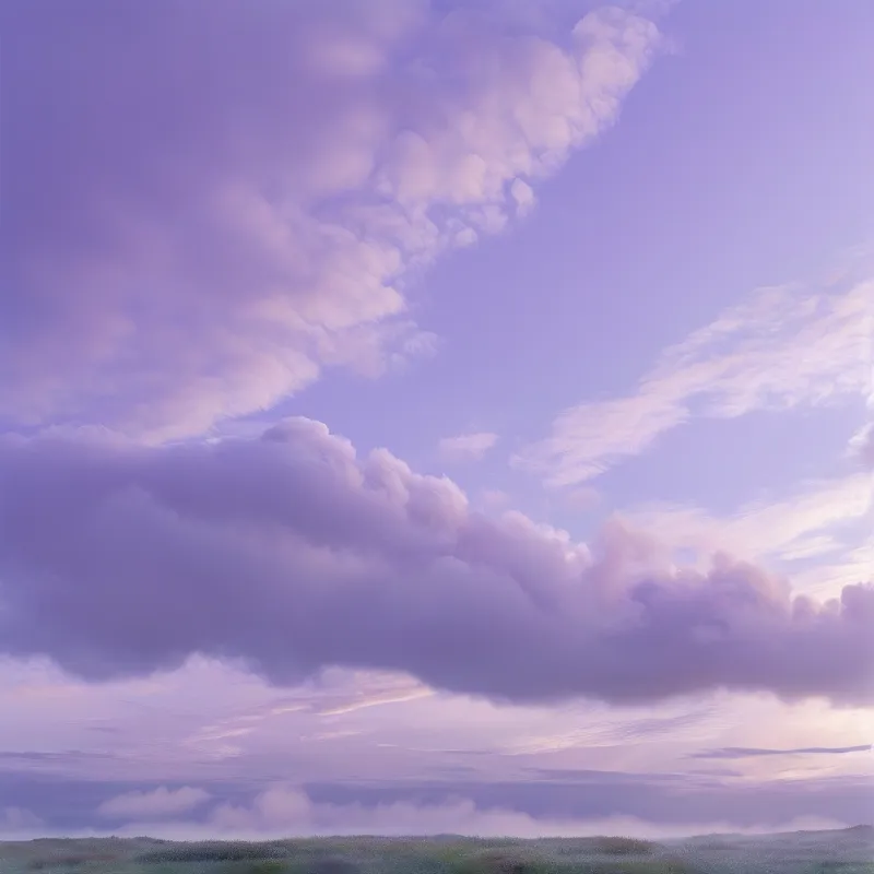 Purple and lavender clouds drift across a vast sky above a distant green horizon during twilight hours.
