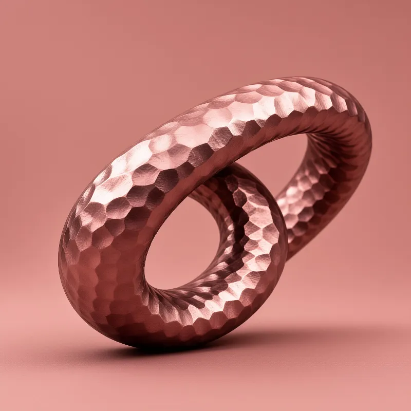 A faceted rose-gold ring curls back through itself above a seamless dusty pink surface with a soft shadow.