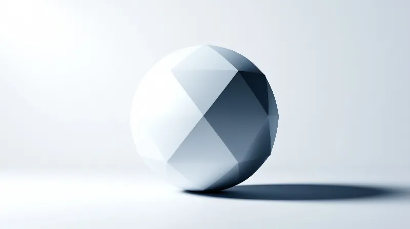 A low-poly sphere rests on a white background with bright lighting on the left and dark shadows on the right side.
