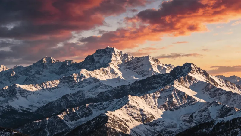 Snow-Capped Peaks Under a Dramatic Sky