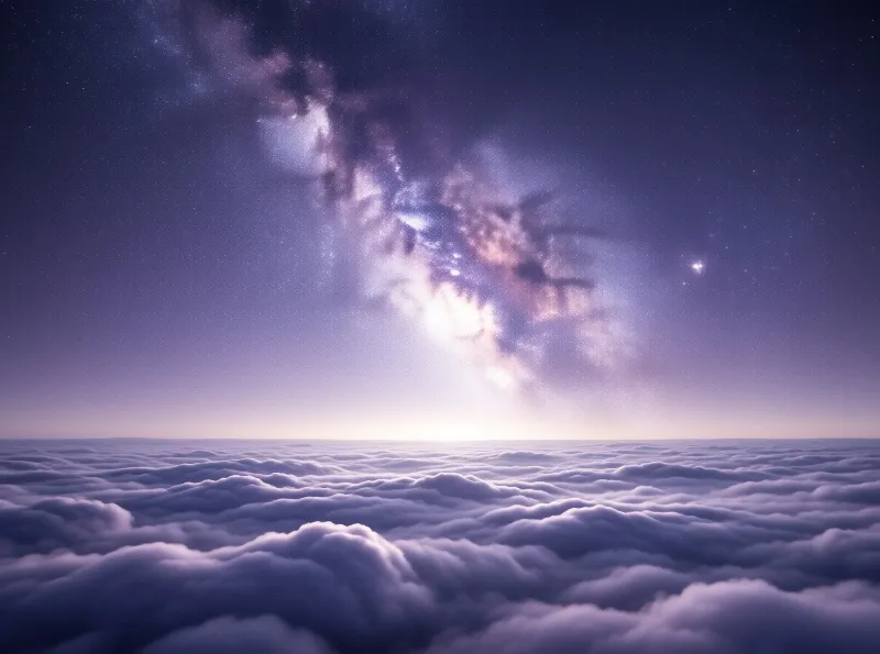The Milky Way galaxy stretches across a purple night sky above a vast expanse of rolling clouds.