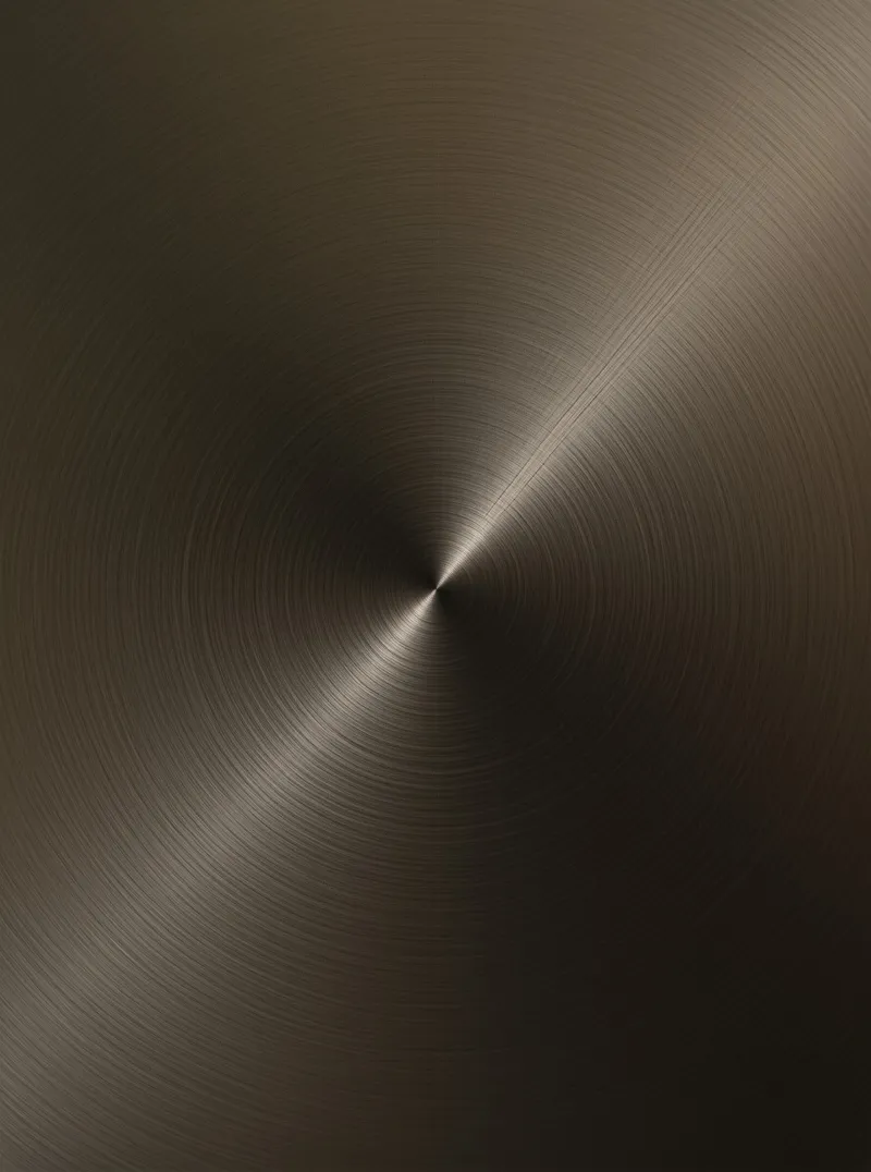 Dark bronze metal surface with concentric circular brush marks intersected by a bright diagonal light reflection.