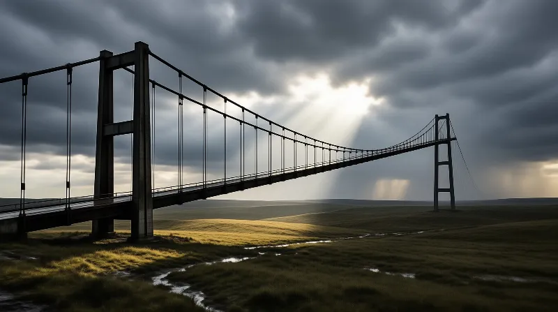 Massive bridge spans rolling green hills while bright sunlight breaks through heavy storm clouds above the landscape.