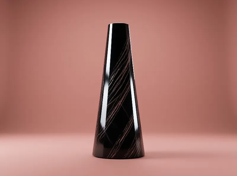 A tall tapered black container featuring diagonal copper metallic striations sits against a smooth pastel pink studio backdrop.