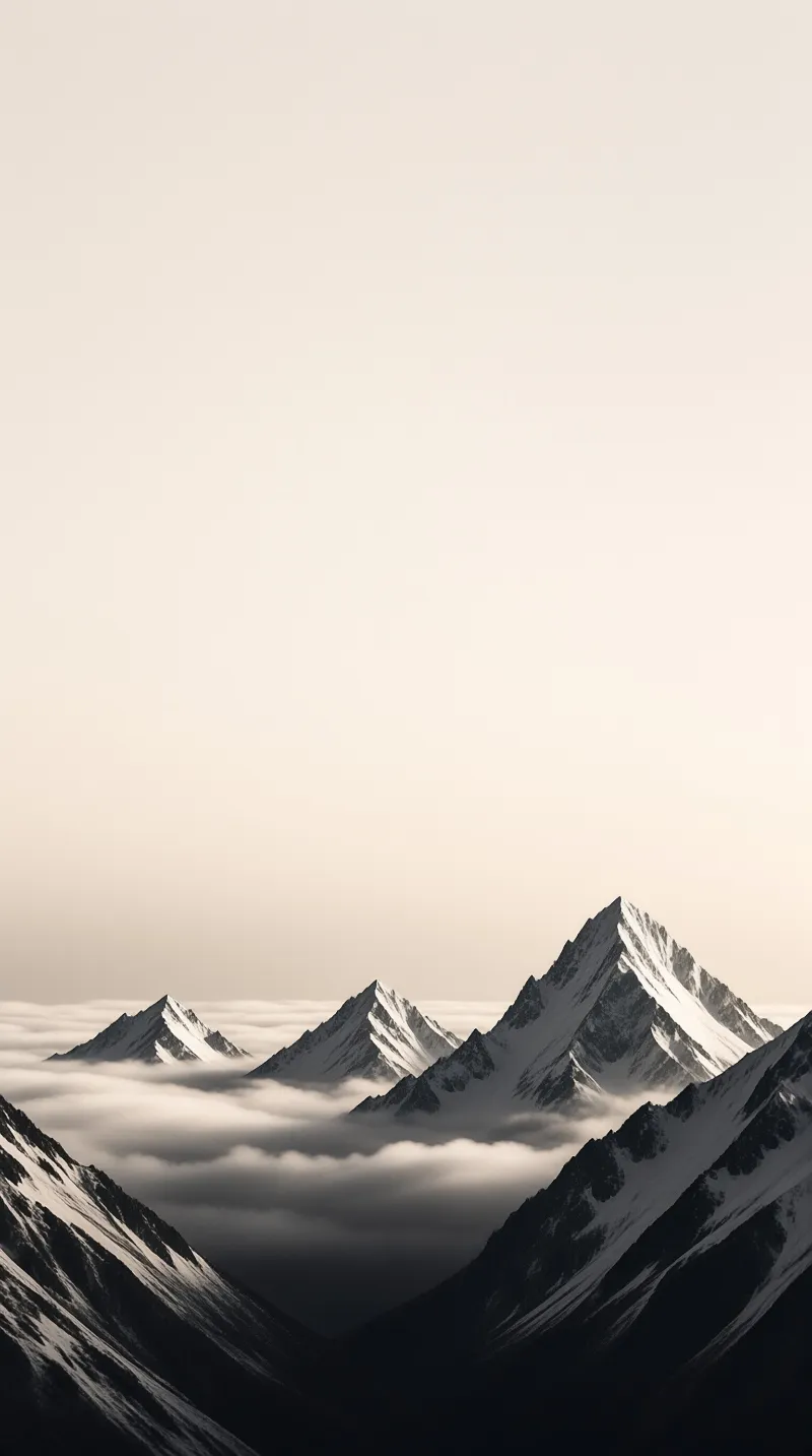 Multiple snow-covered mountain summits emerge from a dense sea of clouds beneath a pale warm beige sky.