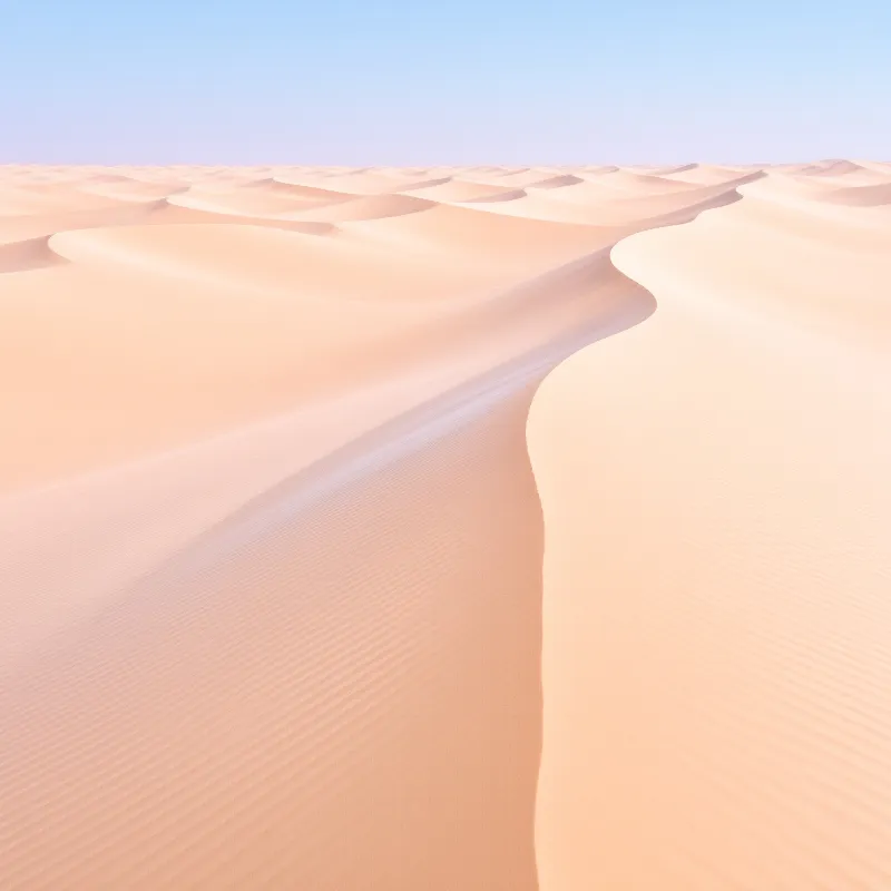 Gentle waves of beige earth ripple across the landscape while a soft shadow defines the ridge against a gradient sky.