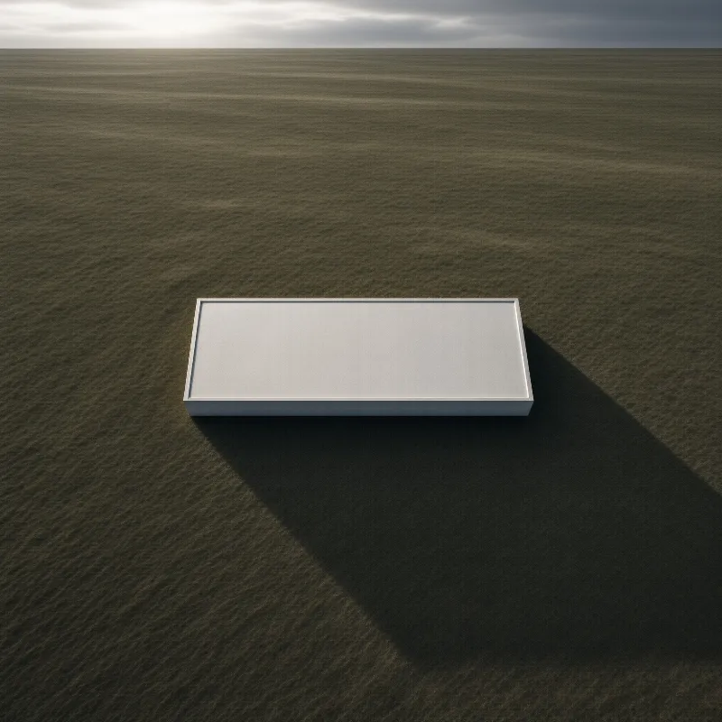 A pale grey low concrete structure rests on an endless brown grassland beneath muted overcast skies.