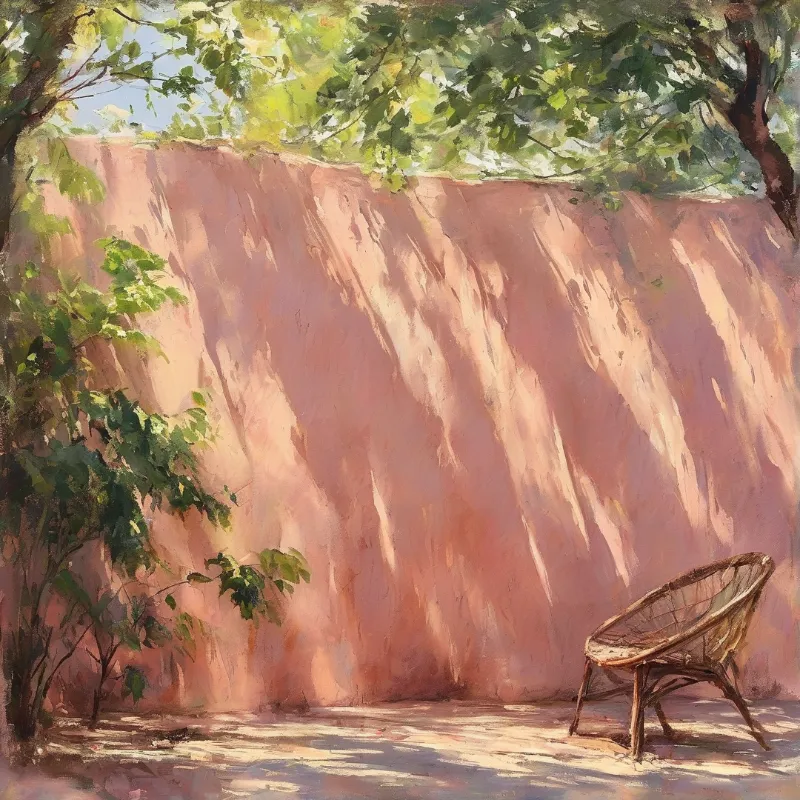 Empty woven rattan chair rests against a sunlit pink stucco wall shaded by overhanging green leafy tree branches