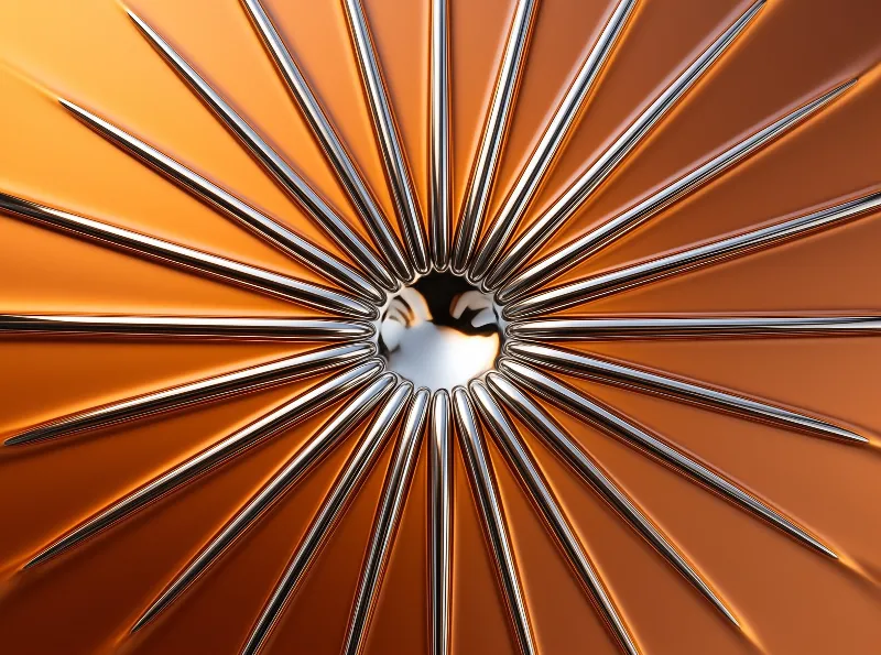A radial array of metallic spikes extends from a dark central opening against a glossy orange surface with sharp highlights