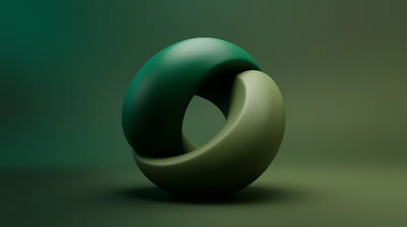 Two smooth interlocking rings in varying shades of green rest on a matte surface under soft diffused lighting.