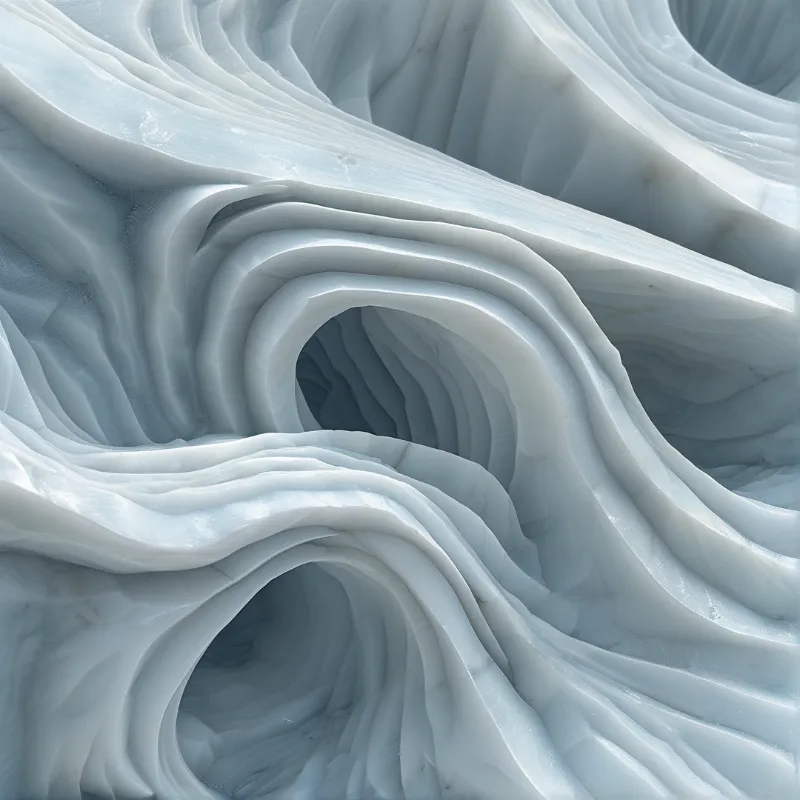 Smooth blue ice structures curving into deep crevasses under soft natural light.