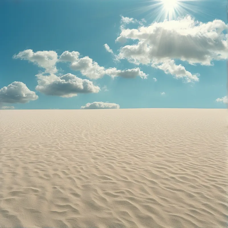Wavy desert sand fills the lower half while bright sun rays shine through scattered clouds in a clear blue sky.