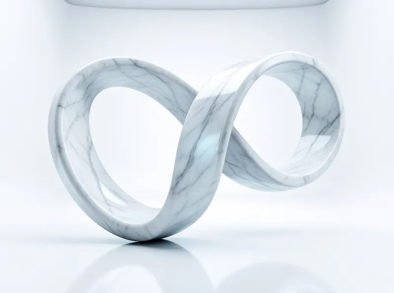 A glossy white marble infinity symbol rests on a smooth white surface with soft lighting.
