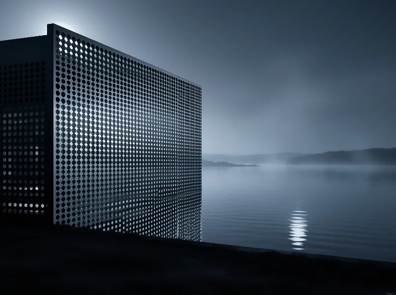 A tall sheet of dotted metal panels stands on a dark shore, catching moonlight above a mist-covered lake.