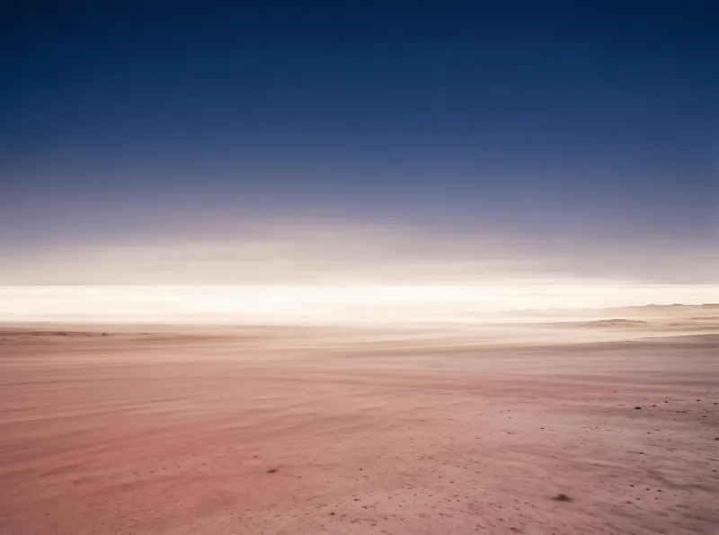 A vast desert flat extending to the horizon with a gradient sky from deep blue to light, bright horizon line and soft pastel ground tones
