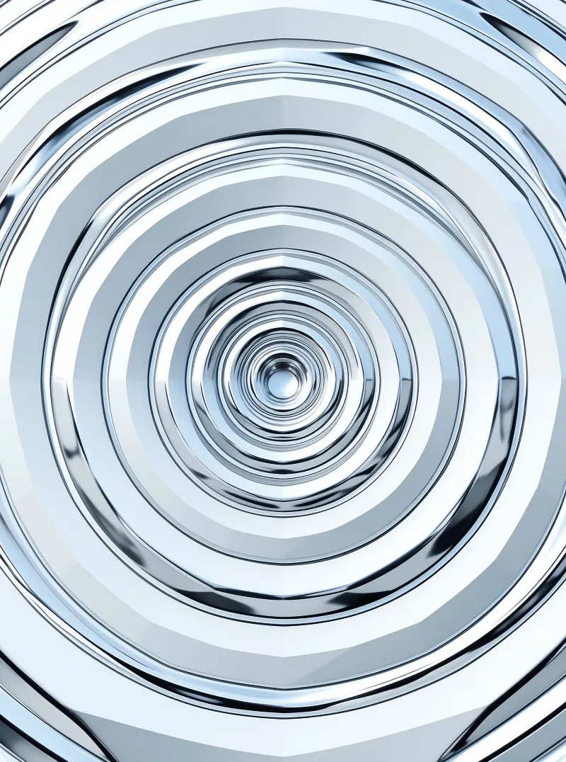 Polished steel circles nest inward like ripples, their bright edges bending light toward a dark center.