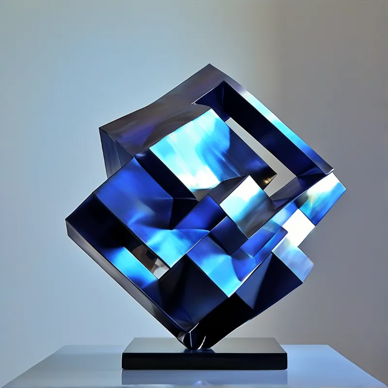 Geometric blue metal sculpture resting on a black base against a plain neutral grey background with sharp highlights