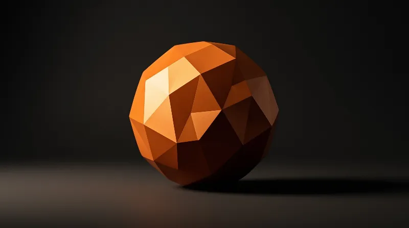 A faceted orange sphere rests on a dark surface, illuminated by strong directional light from the upper left.