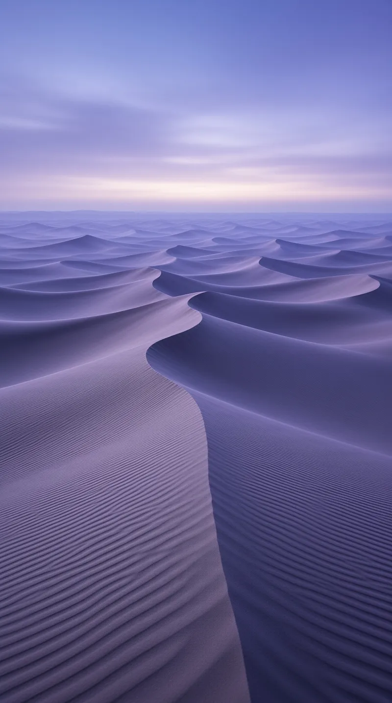 Smooth purple desert dunes ripple across the landscape under a calm violet twilight sky.