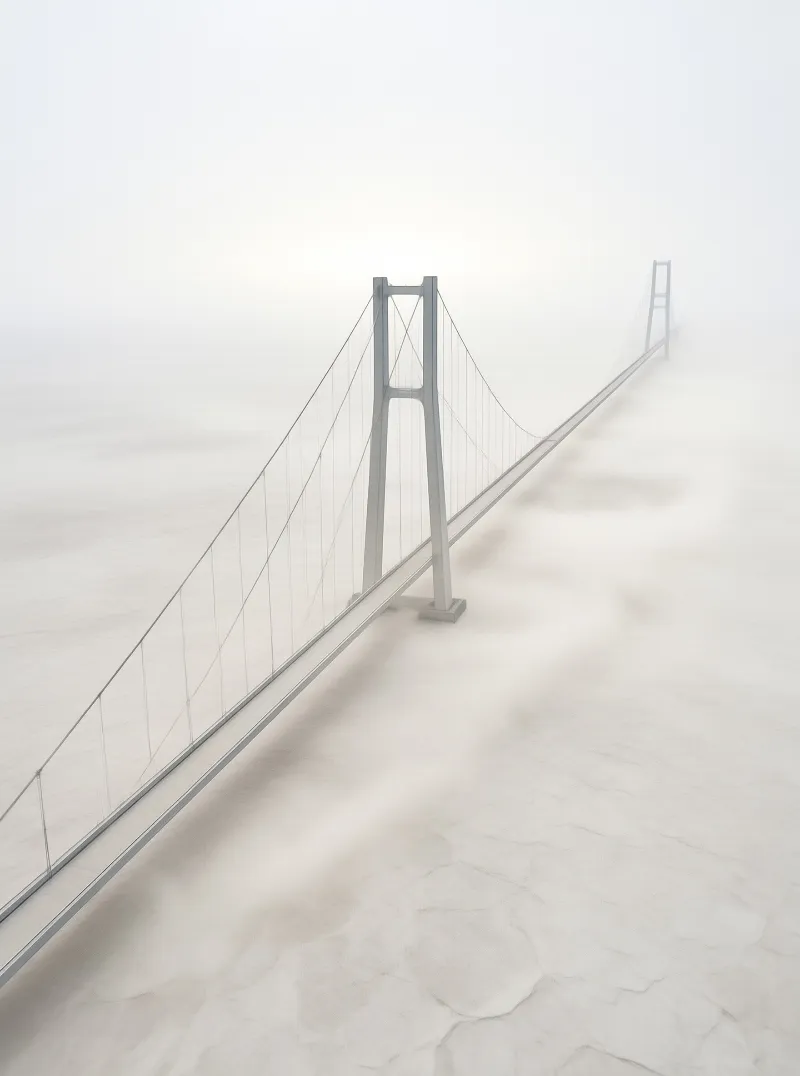 A minimalist suspension bridge stretches through dense fog with soft lighting.