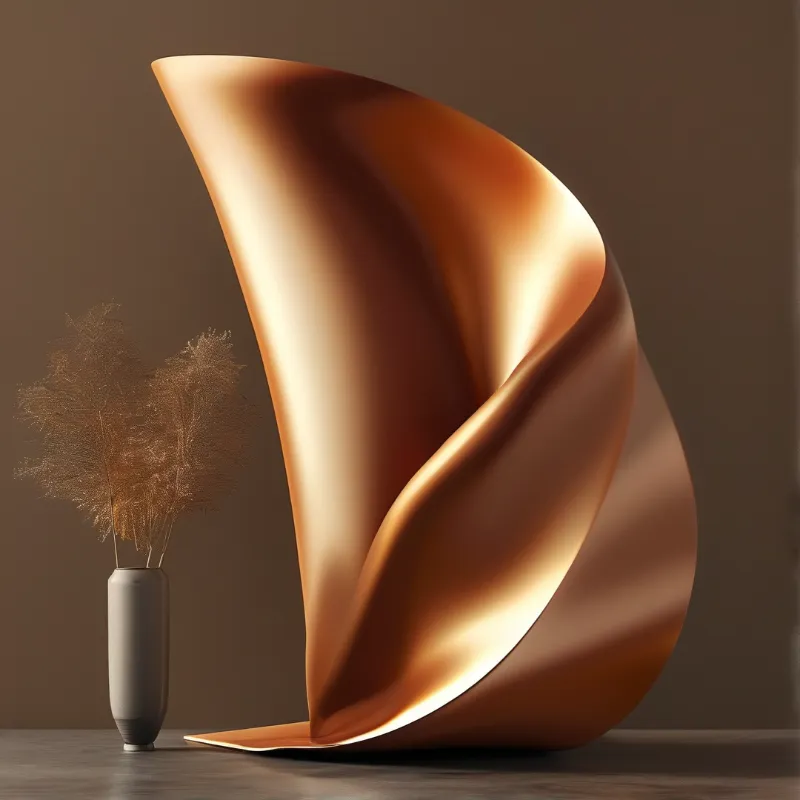 A curved metallic sculpture with golden highlights stands beside a small vase with dried plants against a brown background.