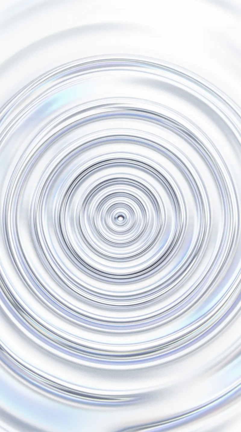 An iridescent liquid spiral with luminous concentric rings and a tiny dark core, set against a soft silver background.