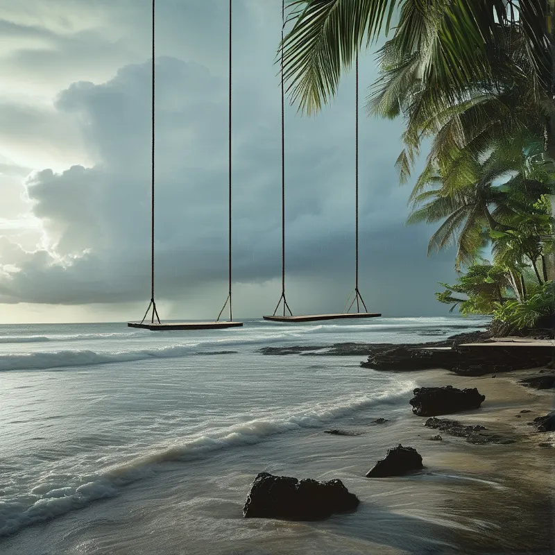 Two wooden planks hang by ropes above the surf near palm trees under a dramatic cloudy sky.