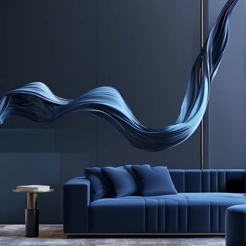 A deep blue channel-tufted sofa sits in a moody charcoal interior while a glossy silk ribbon undulates along the wall.