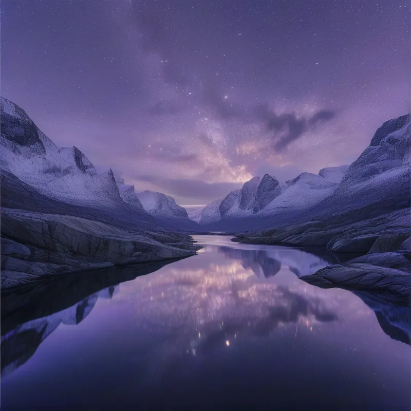 Tall snowy peaks flank a still river reflecting the purple hues of the milky way and scattered stars in the night sky.