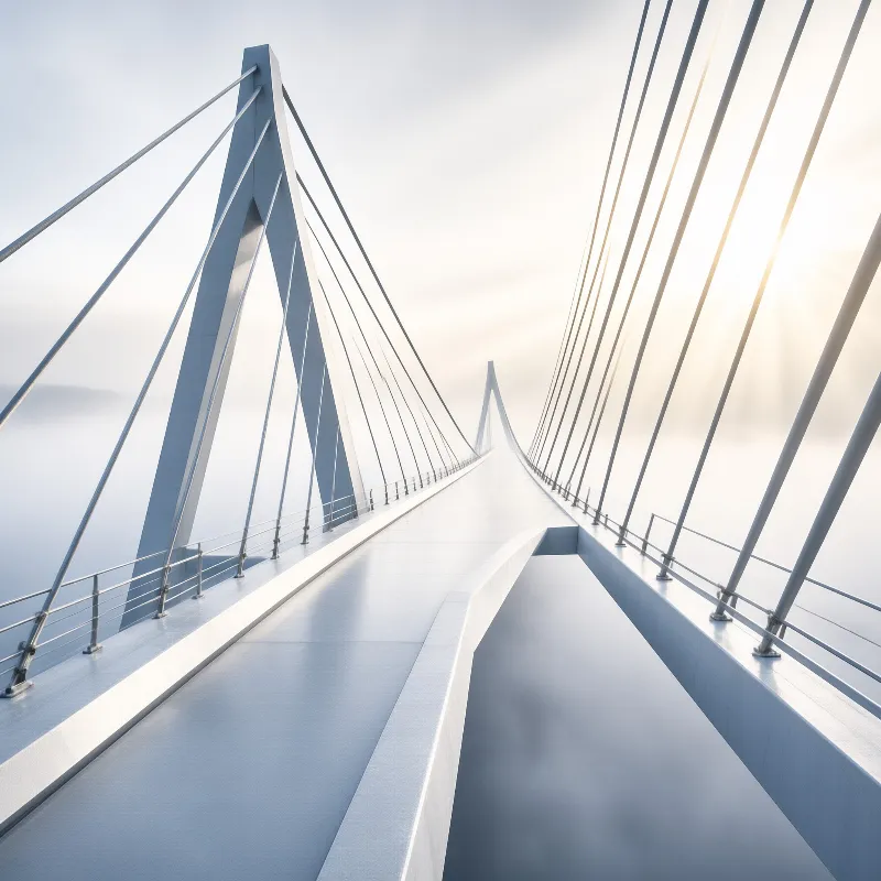 A white cable stayed bridge deck curves toward a tall A shaped pylon as sunlight glows through pale sea fog