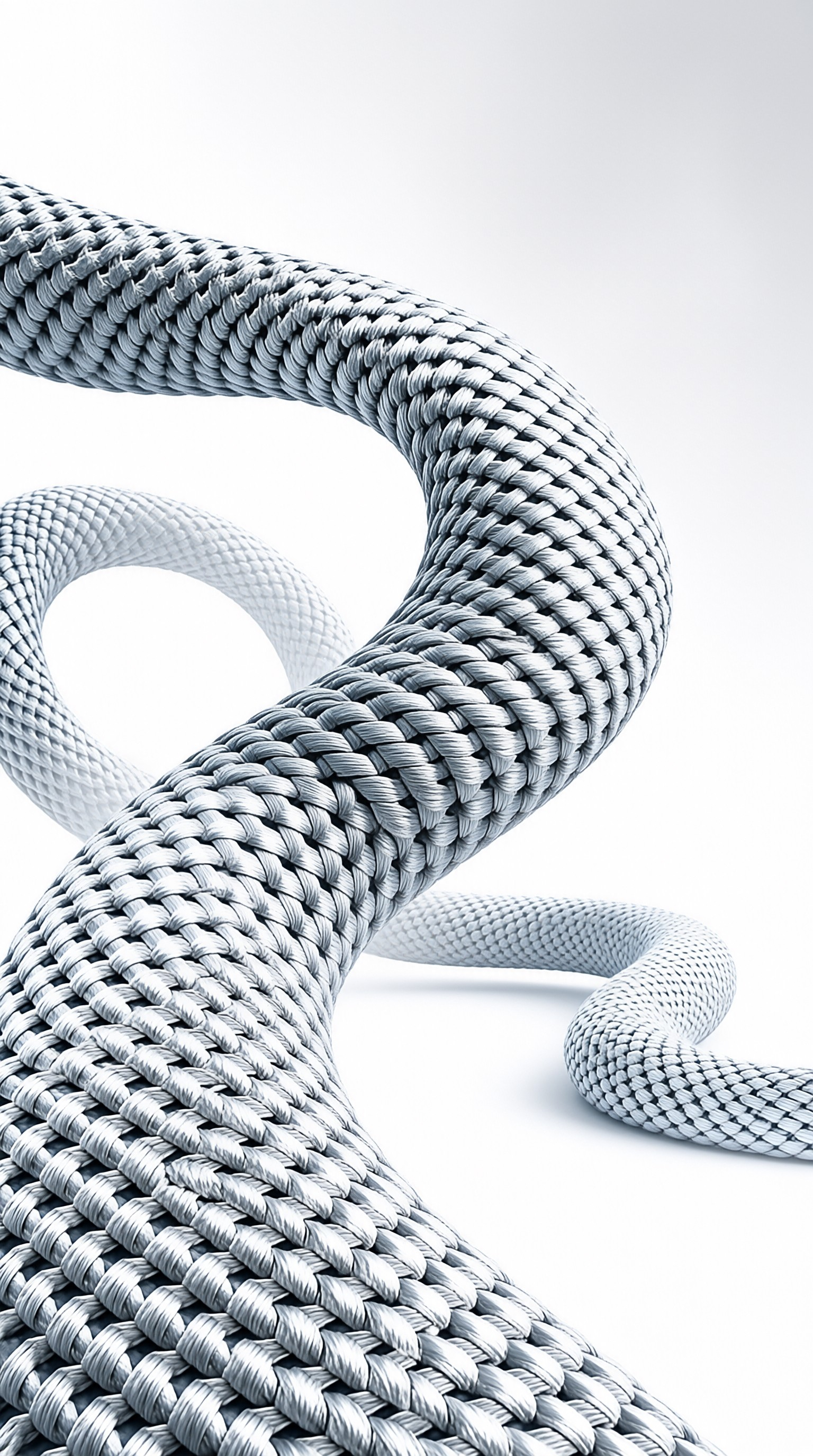 A thick, light grey braided rope twists into a serpentine shape against a stark white surface with soft shadows.
