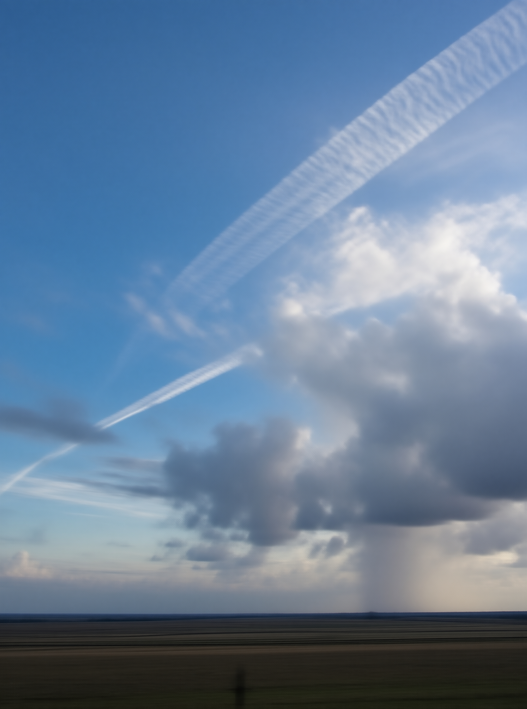 Distant Rain Shaft Over Field