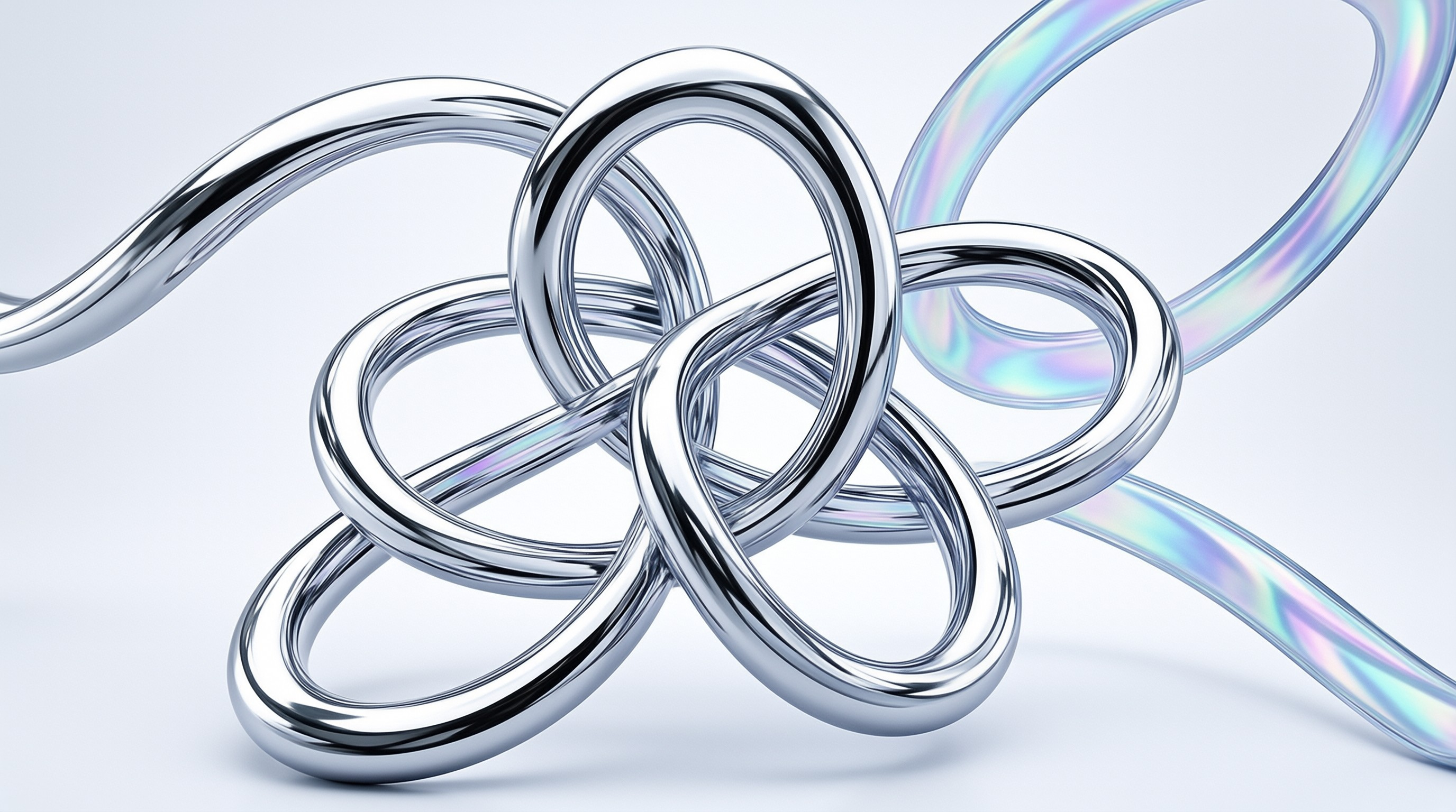 Interwoven polished chrome loops knot together with iridescent holographic ribbons extending from the knot against a pale grey backdrop.