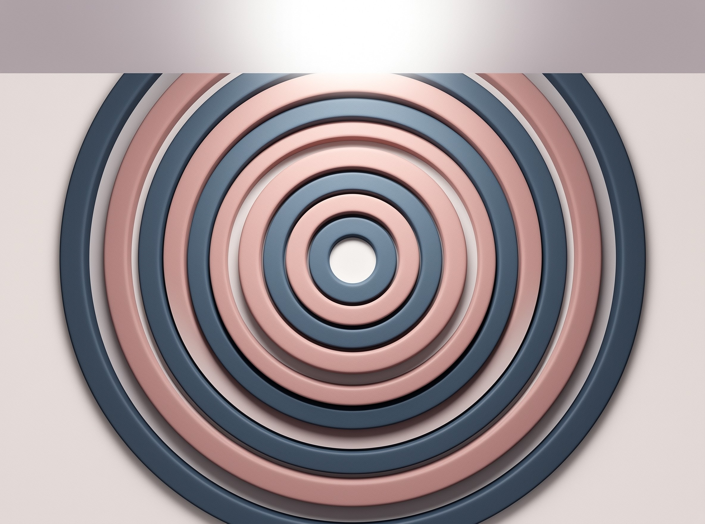 Nested matte circles in navy blue and blush pink form a relief sculpture casting soft shadows on a pale backdrop.