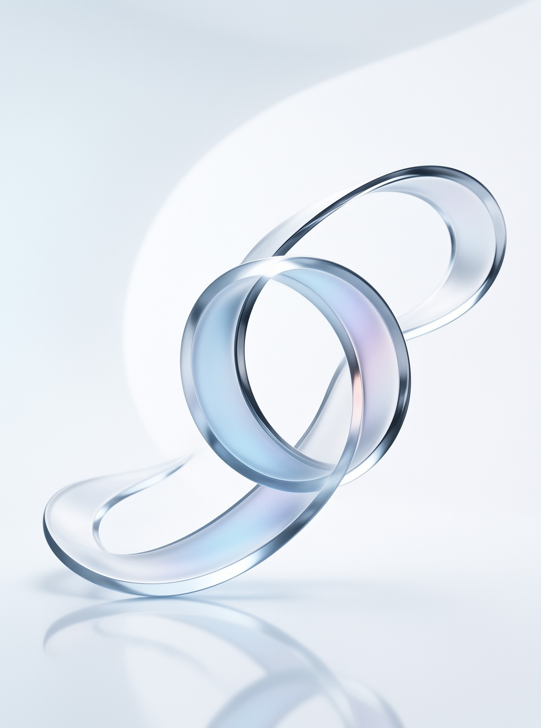 A clear twisted glass ribbon forms a knot shape resting on a reflective white surface under bright light.