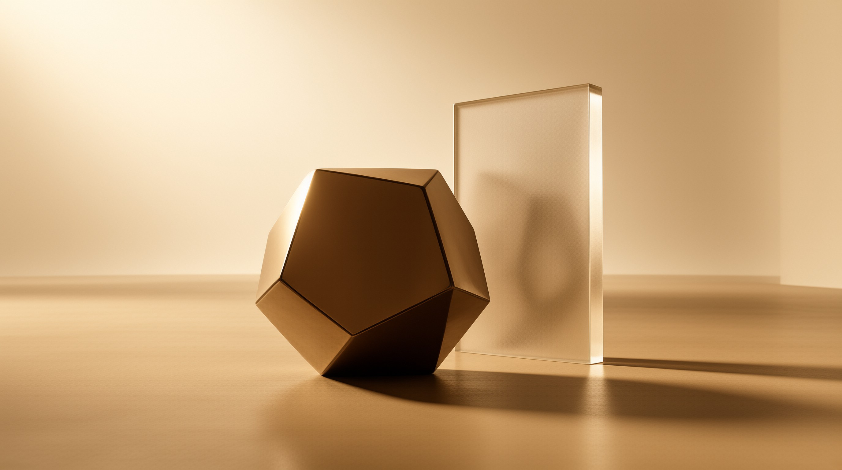 A faceted bronze geometric solid rests beside a translucent frosted glass slab in a warm minimal studio.