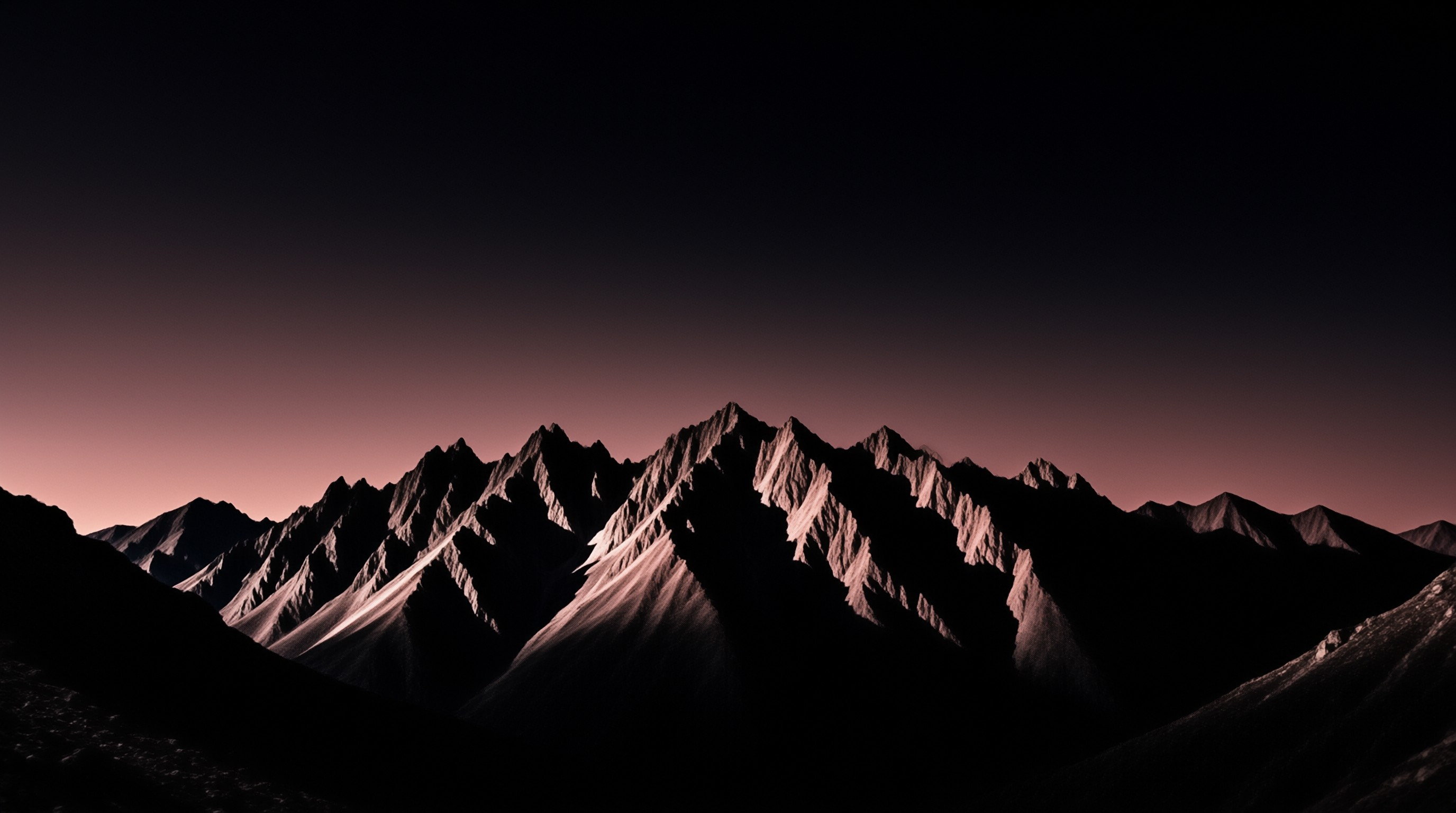 Jagged mountain peaks stand in silhouette against a gradient sky shifting from dark blue to pink near the horizon.