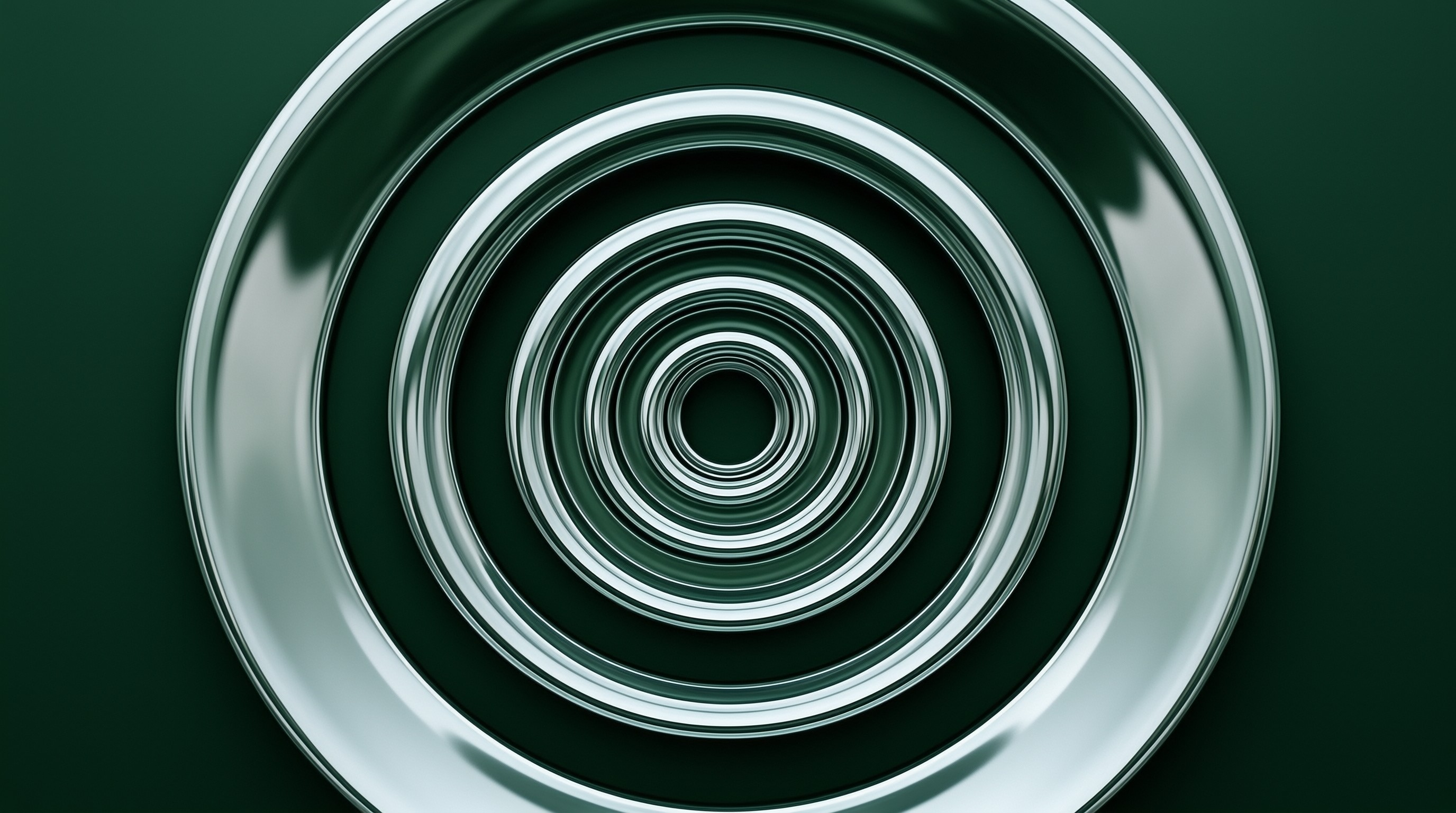 A metallic disc displays concentric green ripples with smooth light reflections across its curved surface.