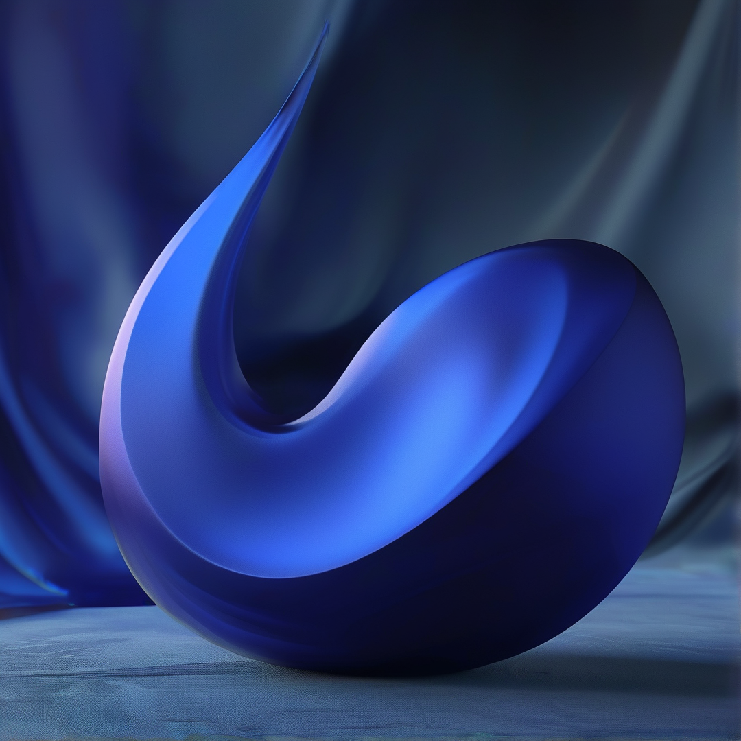 A curved glossy blue glass sculpture rests on pale blue silk with softly lit draped blue silk in the background